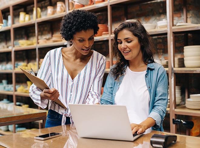 payroll services hero women working on laptop